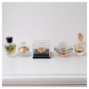 Vintage mini perfume bottle set featuring Lancome Climat Tresor Givenchy Amarige YSL Paris and Montana display collectible rare find gift
