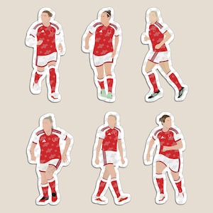 May include: A set of six die-cut stickers featuring football players in red and white kits. Each figure is depicted in a different athletic pose, wearing a red jersey with a subtle pattern, white shorts, and red socks, showcasing various movements.