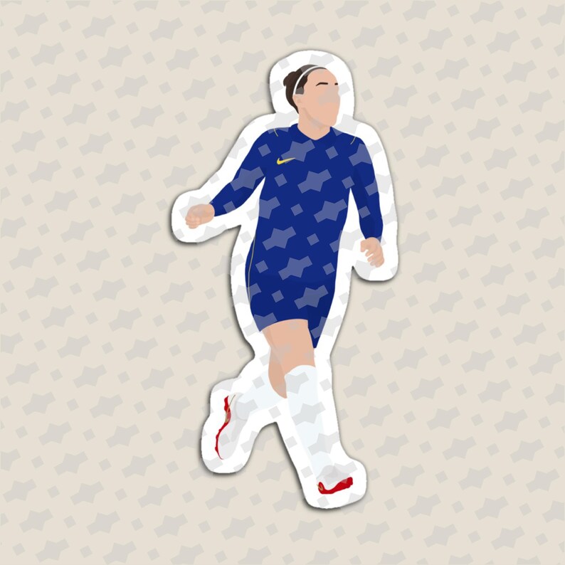 May include: A die-cut sticker featuring a soccer player in a dark blue long-sleeve jersey with a light blue geometric pattern and a yellow logo. The player wears white socks and white soccer cleats with red accents, depicted in a running pose.
