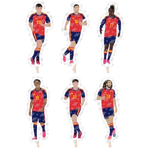 May include: Six die-cut paper cake toppers featuring stylised football players in red and blue uniforms with yellow numbers 20, 16, 17, 19, 22, and 24. Each figure is attached to a thin wooden stick, designed for decorative use on food items.