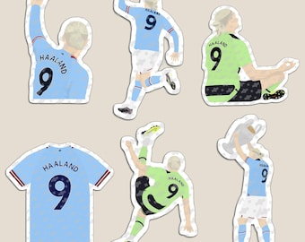 May include: A collection of six die-cut stickers featuring Erling Haaland in various poses. The designs include the player in light blue and lime green jerseys with the number 9, a standalone light blue jersey, and a player lifting a trophy.