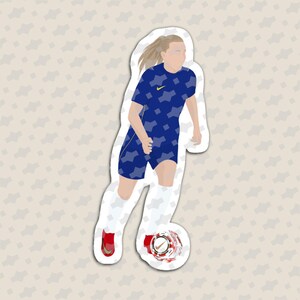 May include: A die-cut sticker featuring a soccer player in a blue patterned jersey with a yellow logo, white shorts, and red cleats. The player is dribbling a soccer ball with a visible logo. The design has a white border and a flat illustration style.