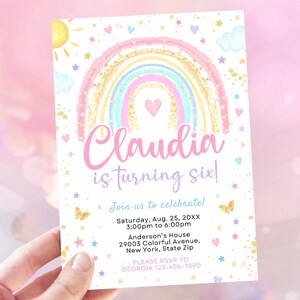 May include: A rainbow-themed birthday invitation with a pink, blue, and yellow rainbow with gold glitter. The invitation says "Claudia is turning six!" and includes details for the party, including the date, time, and location.