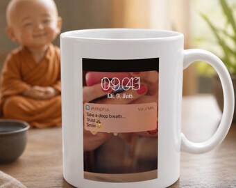 May include: A white ceramic mug featuring a rectangular graphic print of a smartphone screen displaying the time 09:43, the date Di. 9. Jan., and a notification labeled #MINDFUL that reads: Take a deep breath... Trust, Smile.