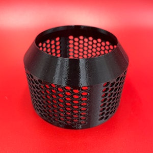 May include: Black plastic cylindrical object with a grid pattern. The object is hollow and has a slightly flared top and bottom.