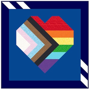 Op de afbeelding: Een hartvormig ontwerp gemaakt van verschillende gekleurde vierkanten van stof. De kleuren zijn rood, oranje, geel, groen, blauw, paars, bruin, zwart en wit. Het hart is geplaatst tegen een donkerblauwe achtergrond.