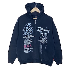 May include: Black zip-up hoodie with a hood and white graphic text. The hoodie features a full-length zipper and multiple text designs on the front. The text includes the words "California" and "USA".