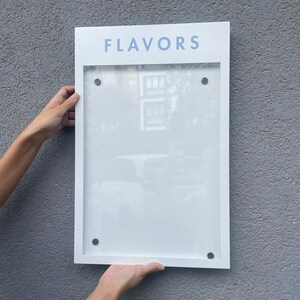 White personalized menu display box with a light blue printed header and a clear acrylic document holder. Contemporary wall mounted business sign for restaurant menus, cafe information and branded hospitality displays.