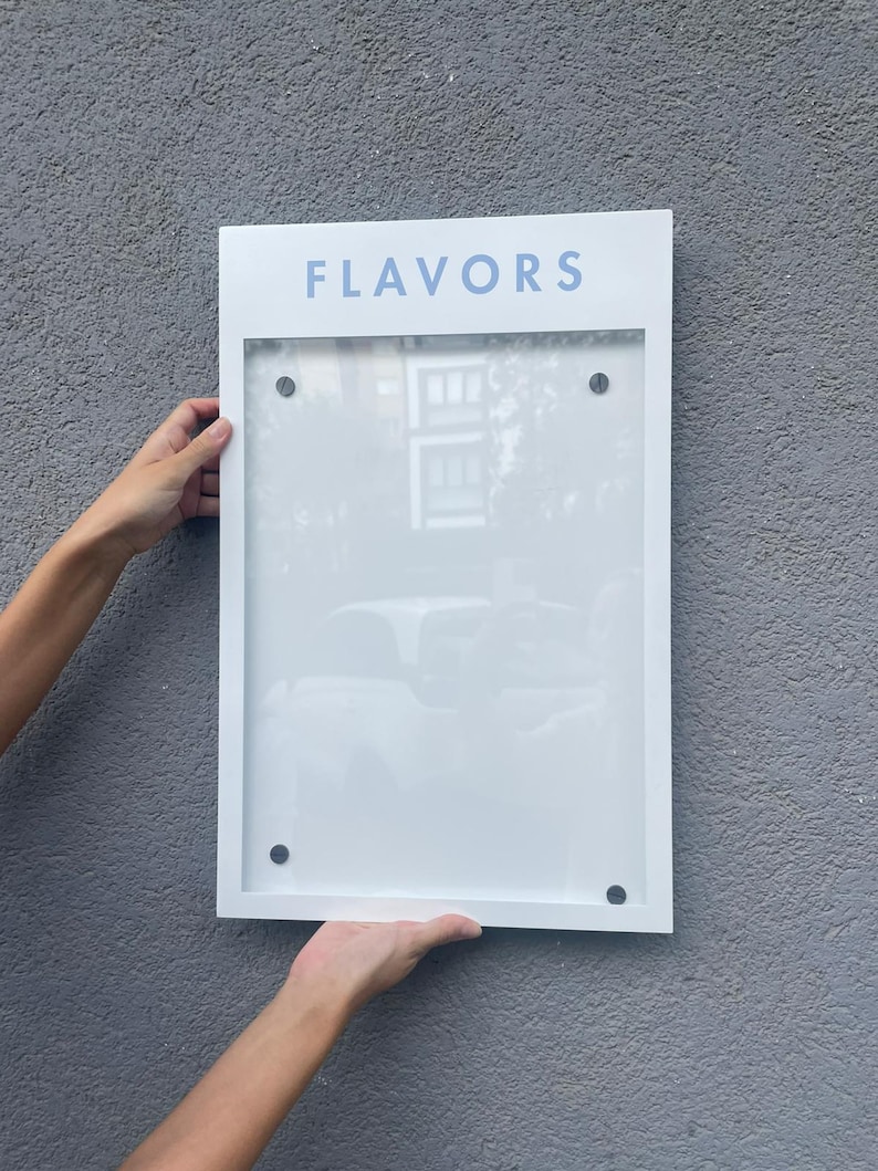 White personalized menu display box with a light blue printed header and a clear acrylic document holder. Contemporary wall mounted business sign for restaurant menus, cafe information and branded hospitality displays.