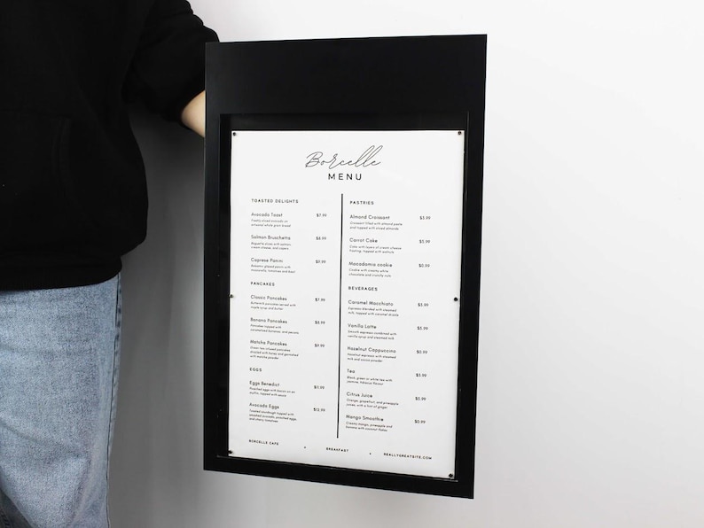 Black rectangular wall menu board featuring a white printed food and beverage list. Minimalist metal restaurant signage for coffee shops, breakfast cafes, bistros and modern hospitality interiors.