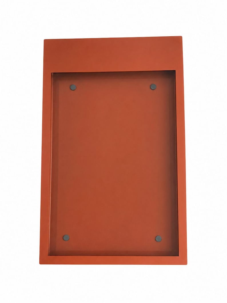 Orange Menu Frame 
Burnt orange metal menu display frame with a recessed rectangular center and four visible mounting points. Custom color wall menu box for modern restaurant interiors, coffee shops and hospitality display applications.