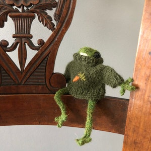 Spring knitted frog in a sweater with embroidered carrot