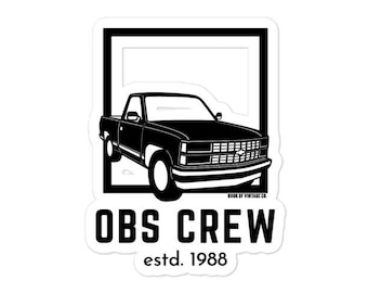 May include: Black and white sticker featuring a silhouette of a black pickup truck with the text "OBS CREW estd. 1988" in a white rectangle.