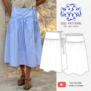 May include: A light blue and white striped wrap skirt with a ruffled waist and tie closure. The skirt is paired with brown sandals. The image also includes a line drawing of the skirt and the text "IGGI PATTERNS THE IDA SKIRT".