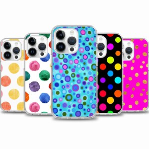 May include: Five different iPhone cases with various colorful polka dot patterns. The cases are clear and show the phone's camera lenses.