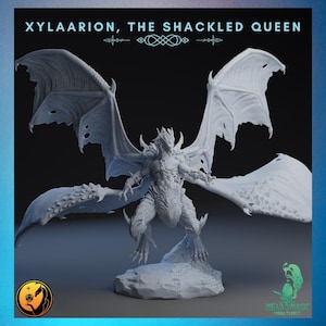 May include: A detailed, gray miniature of Xylaarion, The Shackled Queen, a fantasy creature with large wings and a humanoid torso. The figure is standing on a rocky base. The text "XYLAARION, THE SHACKLED QUEEN" is at the top.