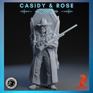 Op de afbeelding: Een grijze harsfiguur van een cowboy met een lange jas, hoed en geweer, staand voor een kist. Het beeldje heeft lang haar en een baard. De tekst "CASIDY & ROSE" staat bovenaan.