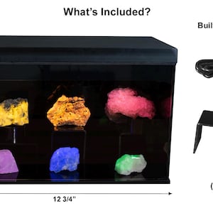 May include: A black acrylic display case with a built-in motion detector, power supply, and two black acrylic mineral stands. The case is 12 3/4 inches wide, 8 1/4 inches tall, and 7 inches deep. The case has a clear glass front and a black interior. The case is lit from the inside and has a black top.