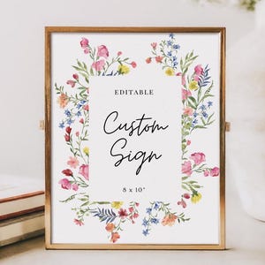 Może przedstawiać: Edytowalny znak o wymiarach 20,3 x 25,4 cm z kwiatową ramką. Znak zawiera napis "Custom Sign" w czarnym, ozdobnym pismie.