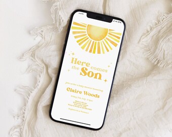 May include: A smartphone displaying a baby shower invitation with a yellow sun graphic and the text "Here comes the Son". The invitation is for Claire Woods and includes the date and time of the shower.