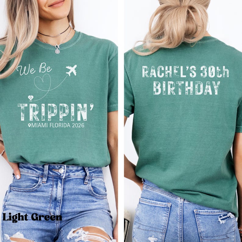 May include: Light green t-shirt with the text "We Be Trippin'" and a graphic of an airplane and a heart. The shirt also says "Miami Florida 2026". The back of the shirt says "Rachel's 30th Birthday".