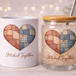 Peut inclure: Une tasse en céramique blanche et un gobelet en verre avec un couvercle en bois, tous deux ornés d'un motif de cœur en patchwork dans les tons de rouge, bleu et beige. Le texte "Stitched Together" est imprimé en dessous.