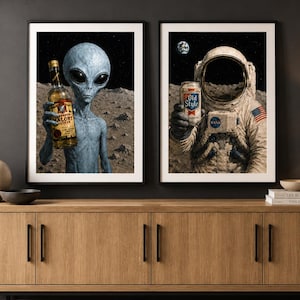 May include: Two framed art prints. One shows a grey alien holding a bottle of liquor, the other an astronaut holding a can of beer. Both are set against a lunar landscape with a starry sky.