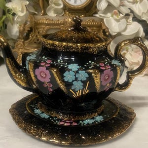 An Antique Victorian Jackfield tea pot with stand