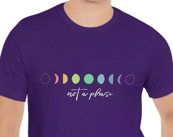 May include: Purple t-shirt with a row of colorful crescent moons and the text "not a phase" in white.