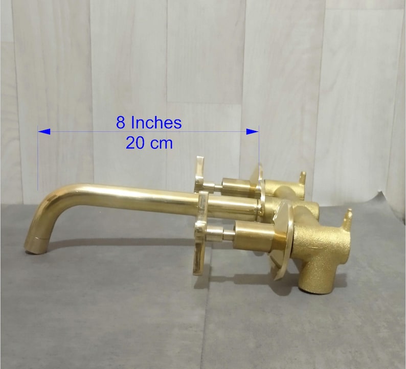 May include: Gold-toned bathroom faucet with two handles and a spout, measuring 8 inches or 20 cm in length.