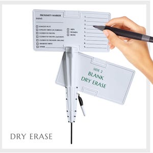 May include: White dry erase board with a black marker attached. The board has two sides, one with a list of proximity marker events and the other side is blank. The board is attached to a white pole with a black tip.