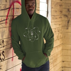 May include: A green hooded sweatshirt with a white graphic of a disc golf basket inside an atom symbol.