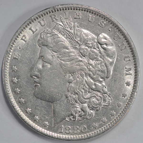 1880 Morgan silver dollar in  Fine or better condition. Comes with protective air tight capsule.