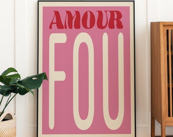 May include: A framed pink and red poster with the text "AMOUR FOU" in a retro font style.