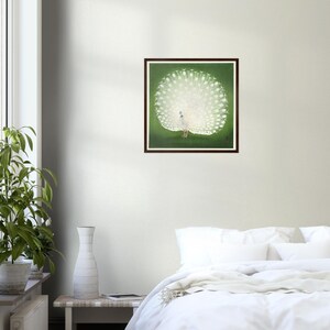 May include: A white peacock with its tail feathers spread out in a fan shape. The peacock is standing on a green background.