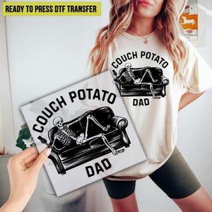 May include: A beige t-shirt and a white square featuring a black and white graphic of a skeleton lounging on a couch, with the words "COUCH POTATO DAD". The t-shirt also has the same graphic. The words "READY TO PRESS DTF TRANSFER" are at the top.