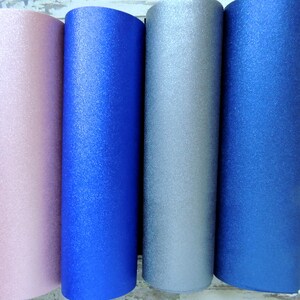 May include: Four rolls of glitter paper in pink, blue, silver, and dark blue.