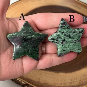 May include: Two green star-shaped stones with black and purple inclusions. The stones are labelled A and B.