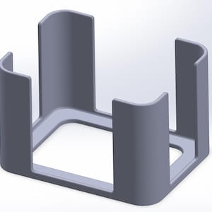 May include: A light gray, open-sided, square-shaped holder with rounded corners and four vertical supports. The supports are evenly spaced and have curved tops, creating a cage-like structure. The design appears to be a 3D rendering.