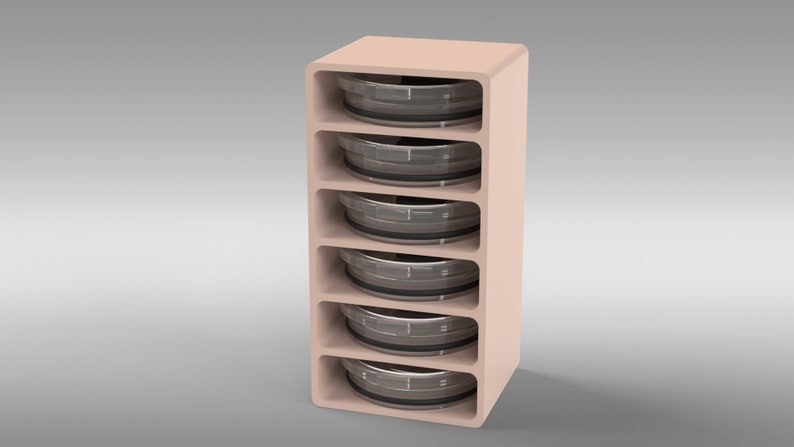 May include: A light peach-colored storage unit with five open shelves, each holding a circular, metallic object. The unit has rounded edges and a minimalist design. The objects appear to be containers or trays.
