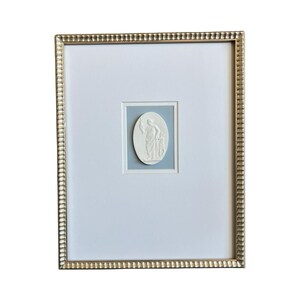 Framed Grand Tour Intaglios against a sky blue textured background in a 11x14 gold scalloped frame