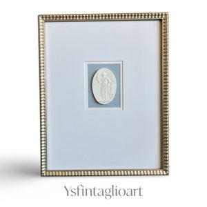 Framed Grand Tour Intaglios against a sky blue textured background in a 11x14 gold scalloped frame