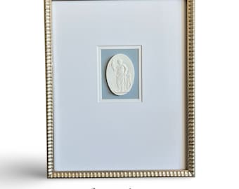 Framed Grand Tour Intaglios against a sky blue textured background in a 11x14 gold scalloped frame