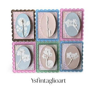 Scalloped acrylic framed floral intaglios on handmade marbled colored paper can be hung or propped on shelf