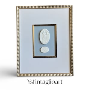 Framed Grand Tour Intaglios against a sky blue textured background in a 11x14 gold scalloped frame