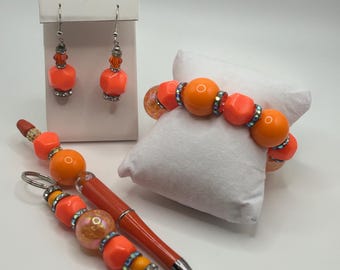 Orange pen, earrings, bracelet, and keychain set (4 item set)