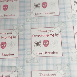 May include: Square stickers with a Spider-Man theme. Each sticker has the text "Thank you for swinging by!" and "Love, Brayden". The stickers feature a spider, a Spider-Man mask, and a spiderweb.