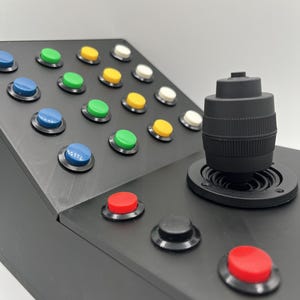 Close-up of the Farming Simulator button box showcasing the detailed layout of push buttons on the panel.