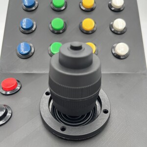 Top-down close up perspective of the Farming Simulator button box displaying the arrangement of control buttons and switches for enhanced gameplay.