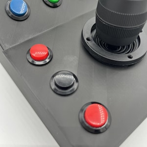 Close-up of momentary switches that accompany the joystick on the Farming Simulator button box, designed for realism and durable use.